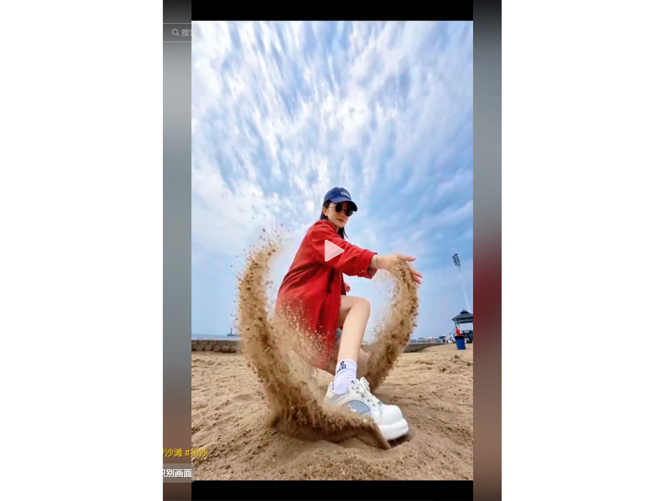 A woman in a red jacket and blue cap playfully thr