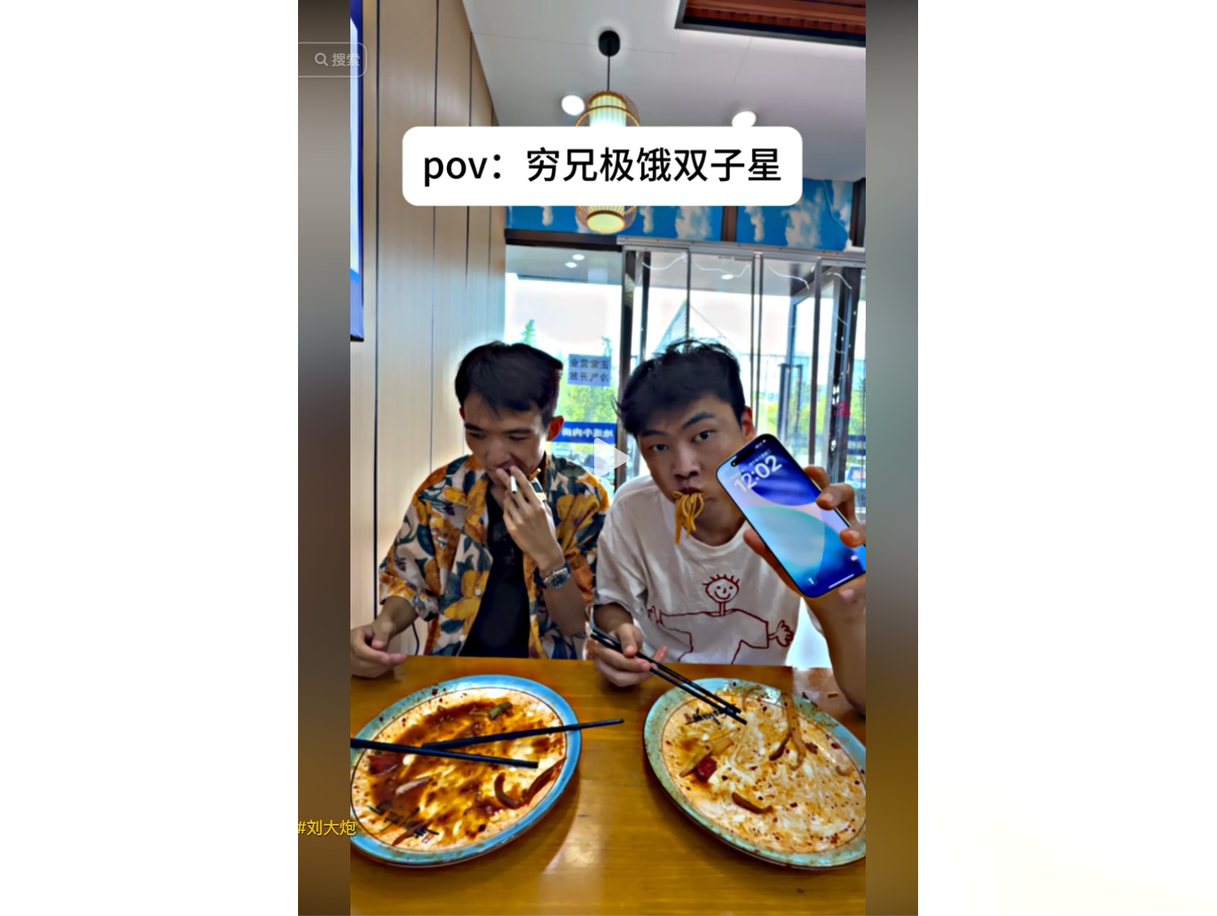 Two men enjoy a meal at a restaurant, one holding 