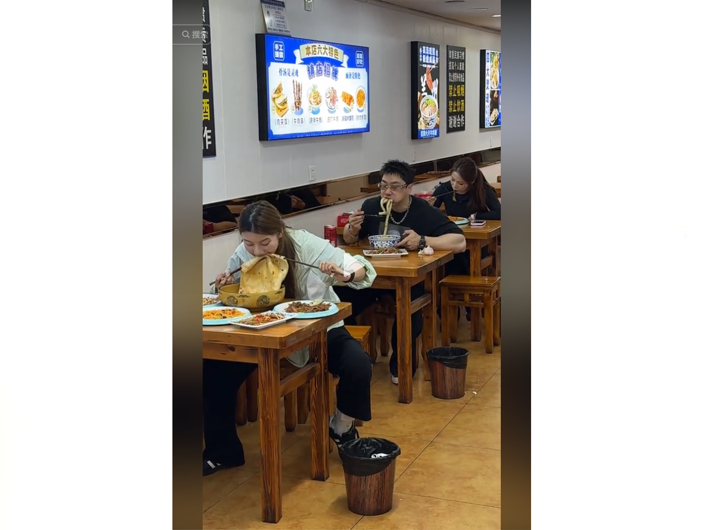 People enjoy a meal at a cozy restaurant, with one